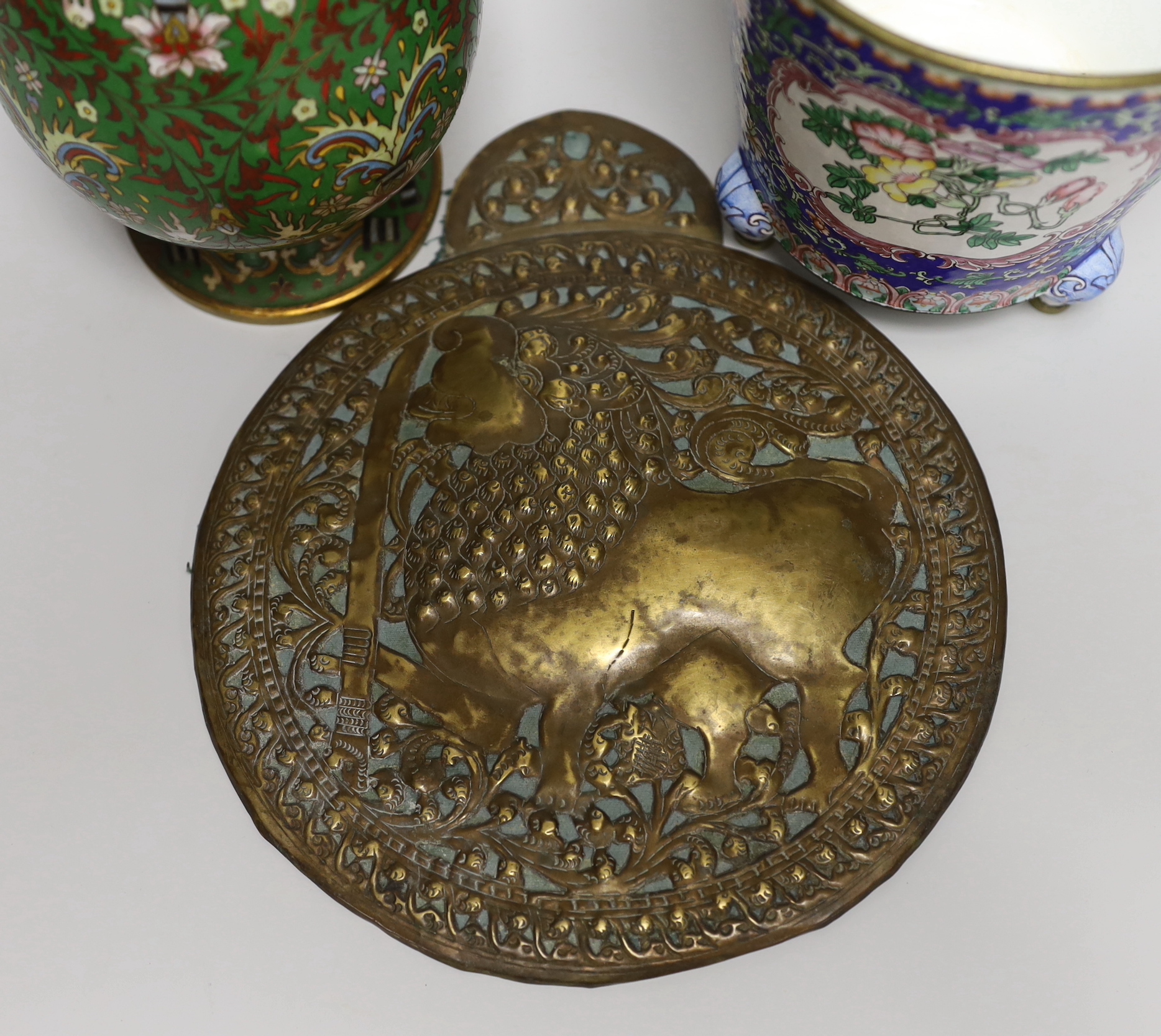 A Chinese Guangzhou enamel vase, a cloisonné enamel vase and an Indonesian brass panel, tallest 26cm high